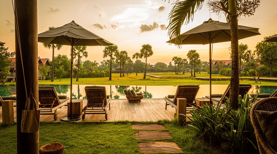 Luxury stilted wooden villa at Phum Baitang surrounded by green rice fields in Siem Reap